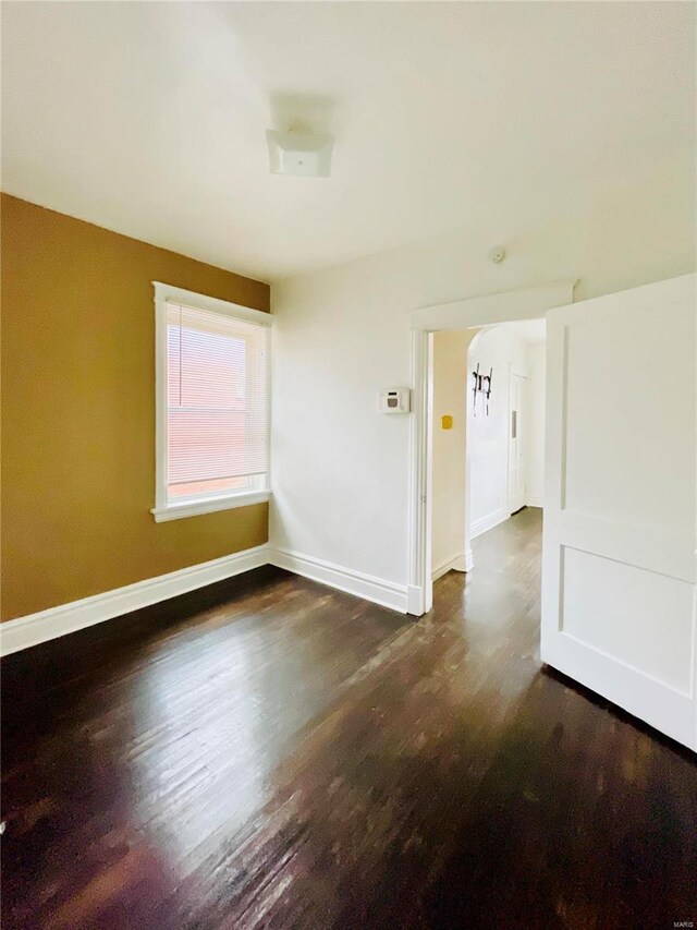 empty room featuring dark hardwood / wood-style flooring