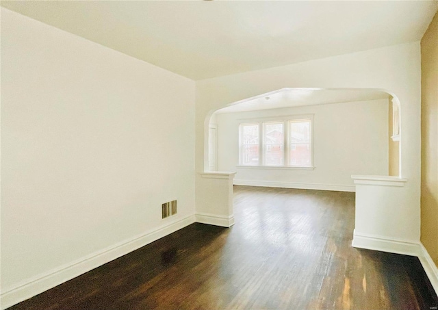 empty room with dark wood-type flooring