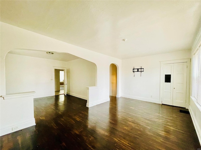 spare room with dark hardwood / wood-style flooring