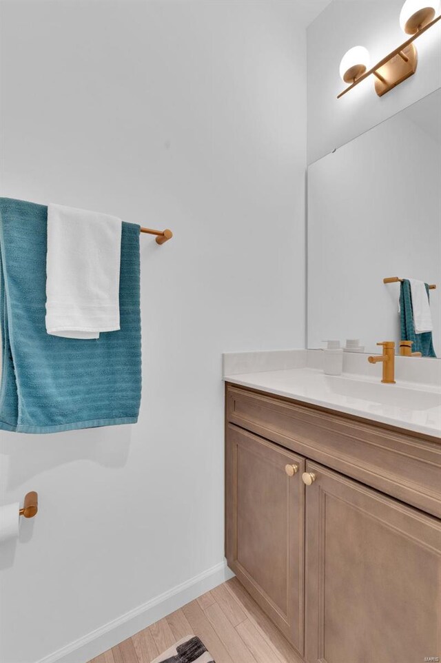 bathroom with hardwood / wood-style flooring and vanity