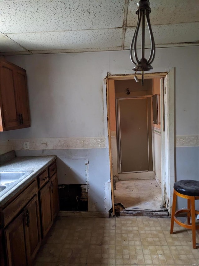 kitchen with pendant lighting and a drop ceiling