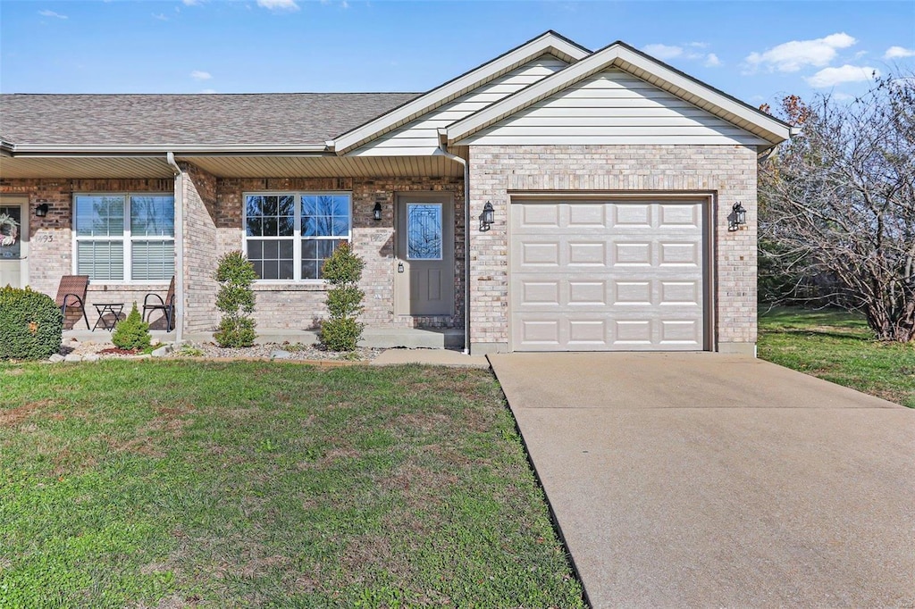 ranch-style home featuring a front yard and a garage