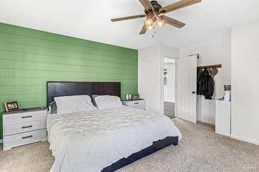 bedroom with ceiling fan and light carpet