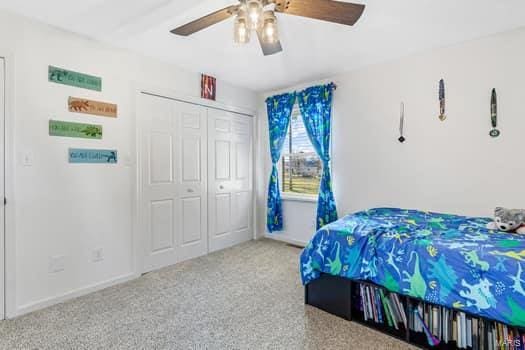 bedroom with ceiling fan and a closet