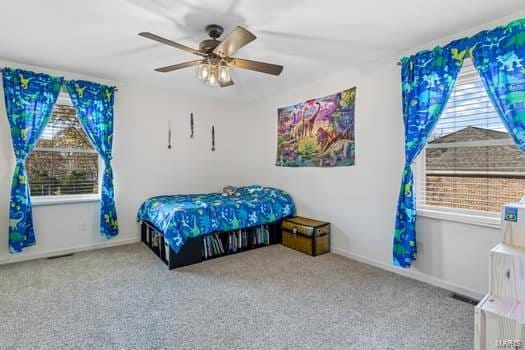 bedroom with ceiling fan and light colored carpet