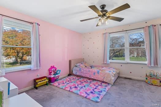 bedroom featuring ceiling fan and light carpet