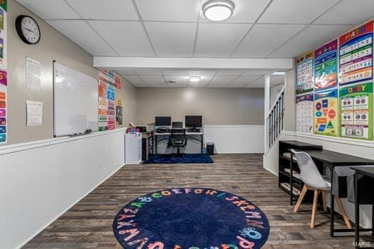 rec room featuring a paneled ceiling and dark hardwood / wood-style flooring