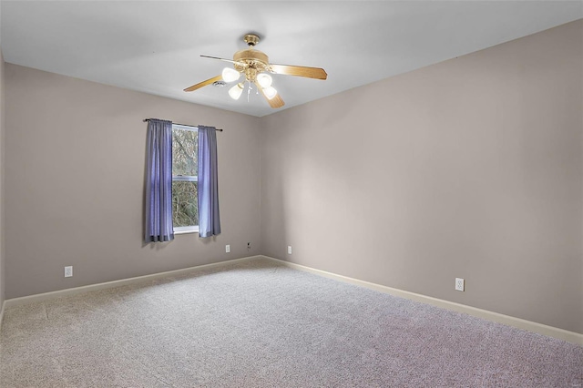 unfurnished room featuring ceiling fan and carpet