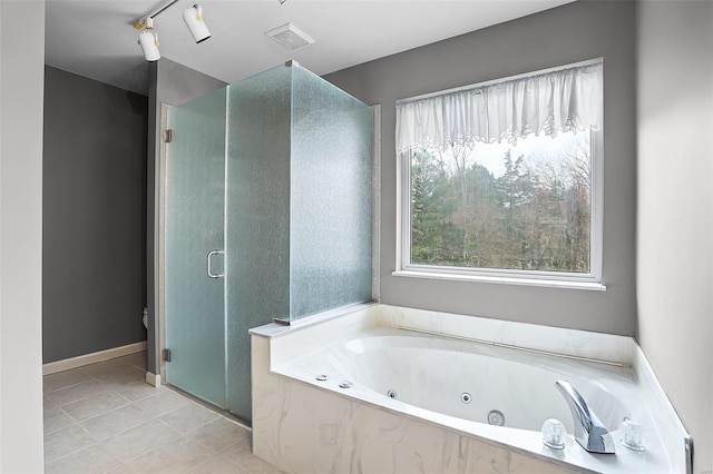 bathroom with tile patterned floors, separate shower and tub, and track lighting