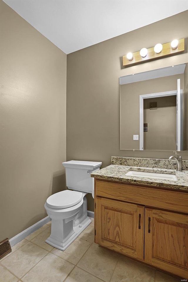 bathroom with tile patterned floors, vanity, and toilet