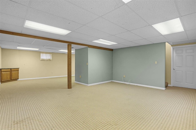 basement featuring carpet flooring and a drop ceiling