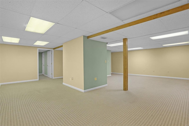 basement with carpet flooring and a paneled ceiling