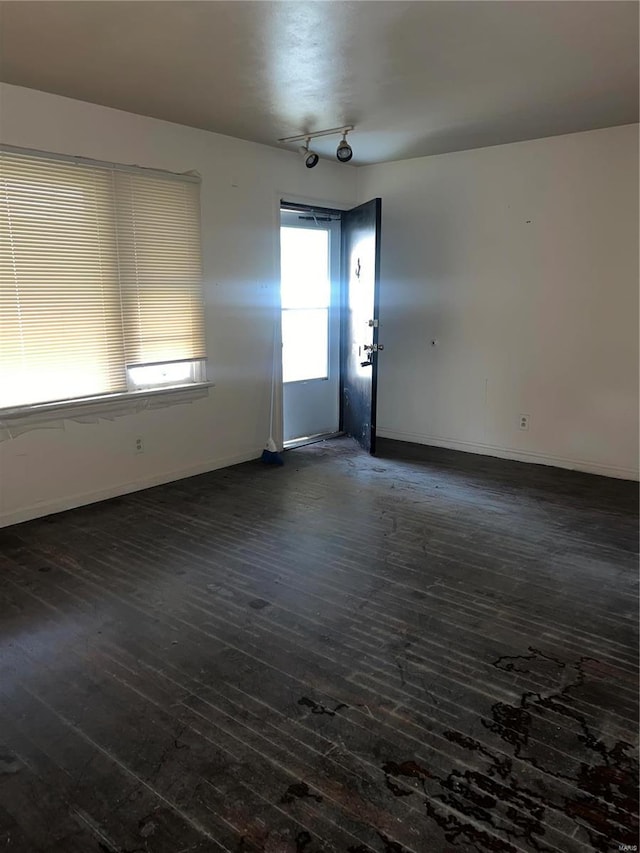 spare room featuring dark hardwood / wood-style flooring