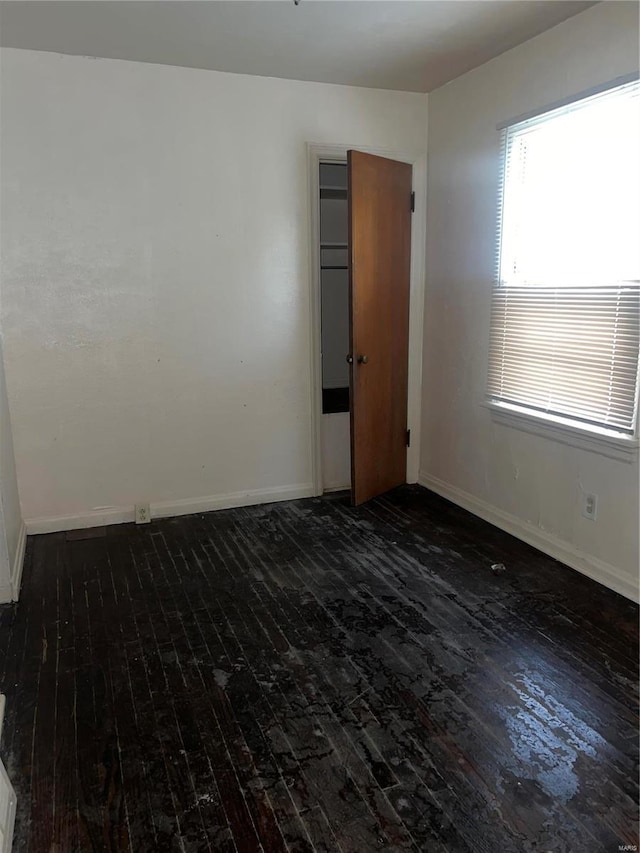 spare room with dark hardwood / wood-style flooring