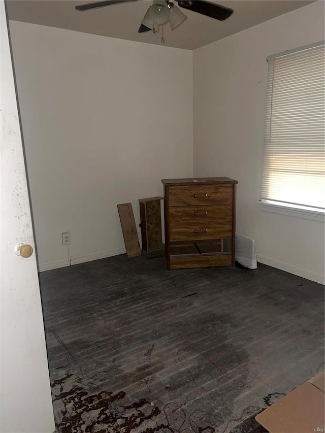 empty room featuring ceiling fan and dark wood-type flooring