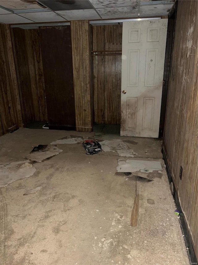 basement featuring wood walls