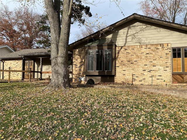 view of home's exterior with a yard