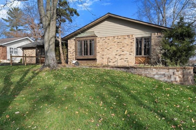 rear view of property with a lawn