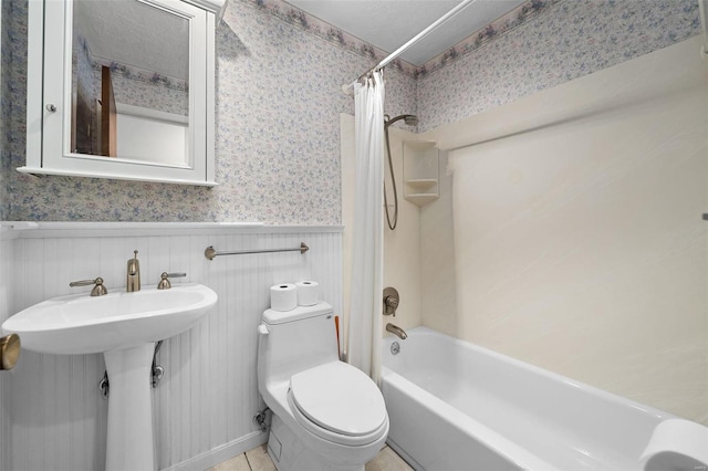 full bathroom with shower / tub combo, a textured ceiling, toilet, and sink