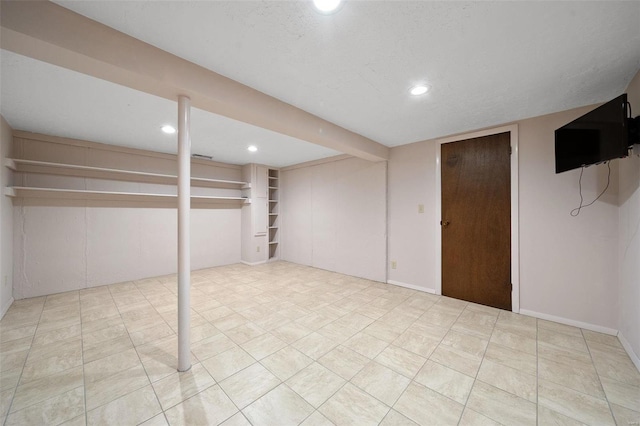 basement featuring a textured ceiling