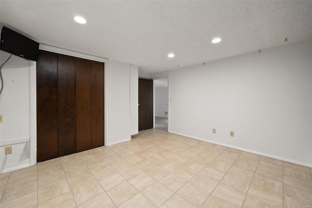 unfurnished bedroom with a textured ceiling