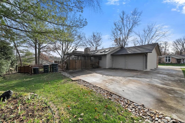 exterior space with a garage and a lawn