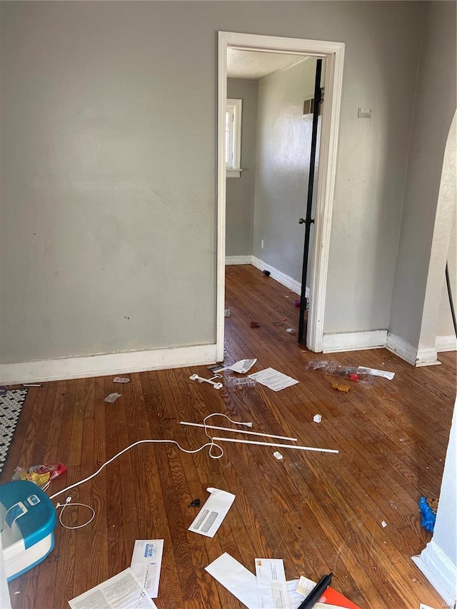 unfurnished room featuring dark wood-type flooring