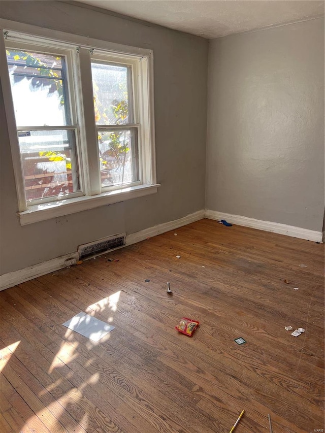 unfurnished room with hardwood / wood-style flooring