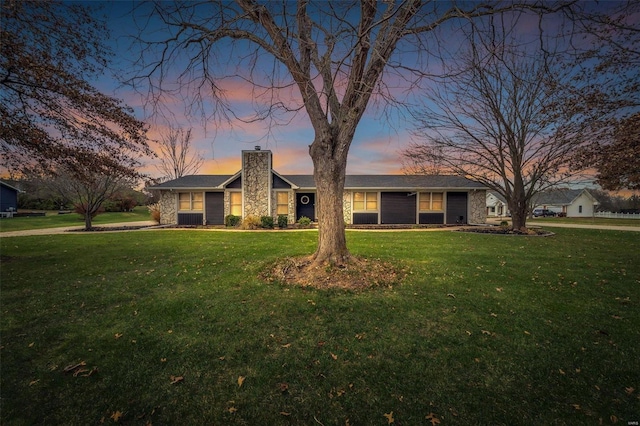 ranch-style home featuring a yard