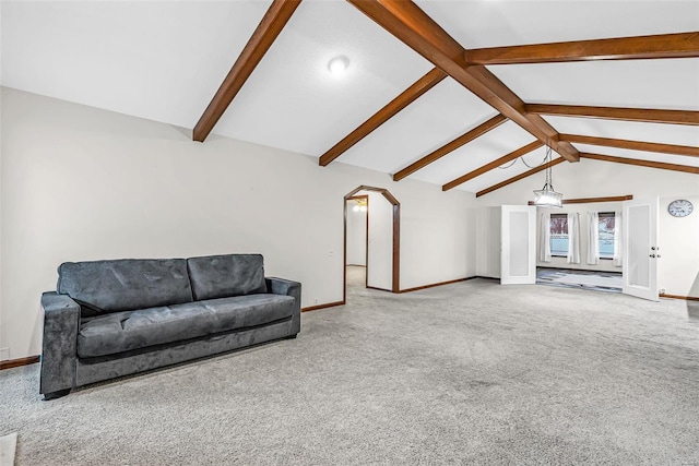 carpeted living room with lofted ceiling with beams