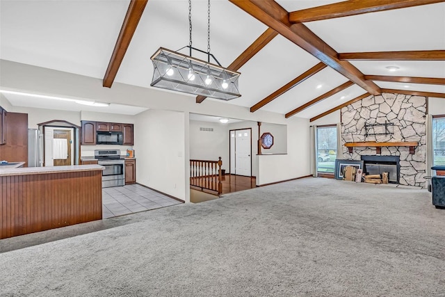 living room featuring light carpet, vaulted ceiling with beams, and a stone fireplace