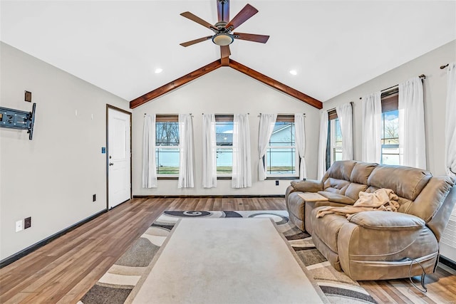 living room featuring beamed ceiling, ceiling fan, light wood-type flooring, and high vaulted ceiling