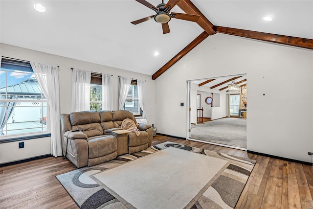 living room featuring hardwood / wood-style floors, ceiling fan, and beam ceiling