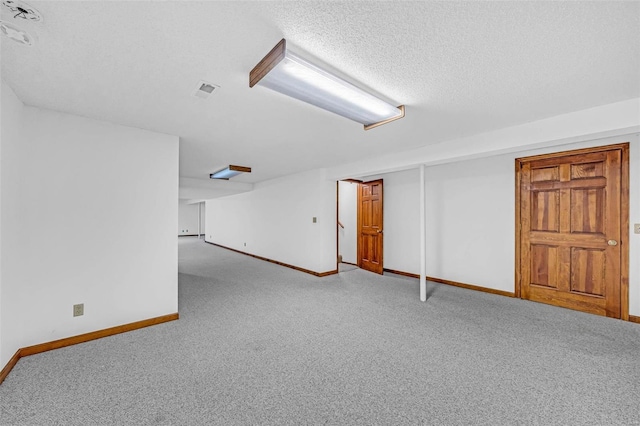 interior space featuring a textured ceiling and carpet floors