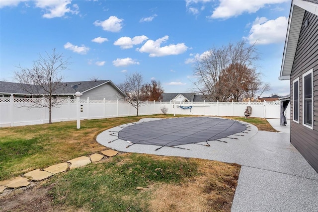 view of yard featuring a patio and a covered pool