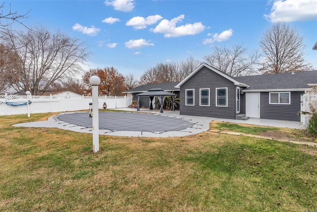 back of house featuring a gazebo, a yard, a patio, and a covered pool