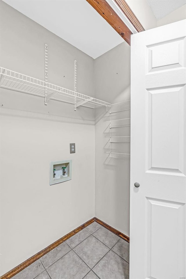 laundry area featuring light tile patterned floors and washer hookup