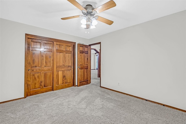 unfurnished bedroom with ceiling fan and light carpet