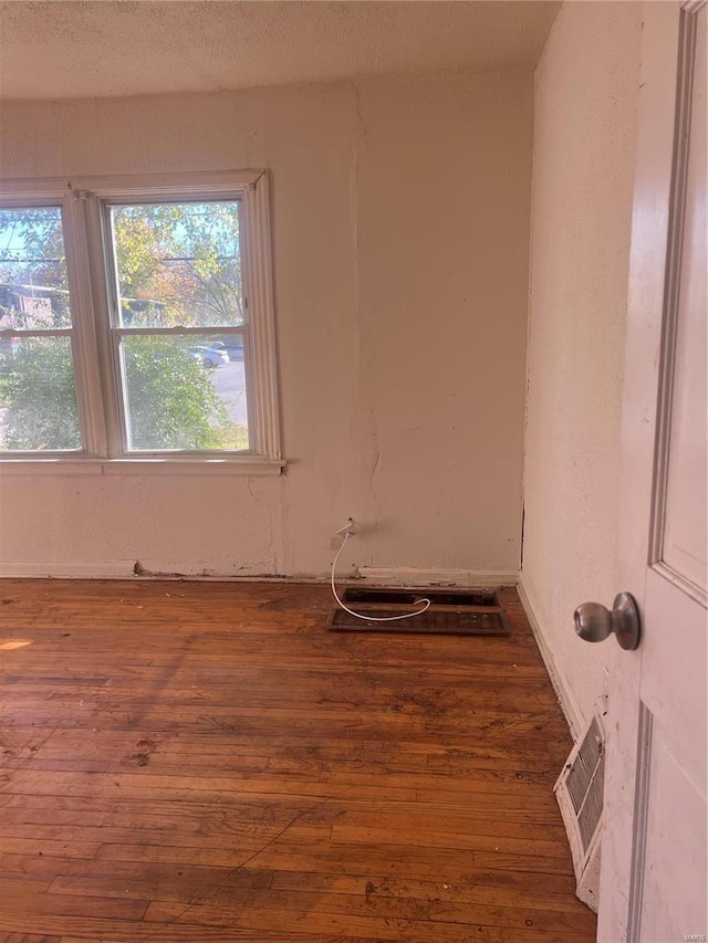 empty room featuring dark wood-type flooring