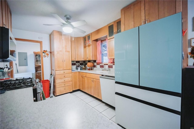 kitchen with dishwasher, electric panel, sink, ceiling fan, and decorative backsplash