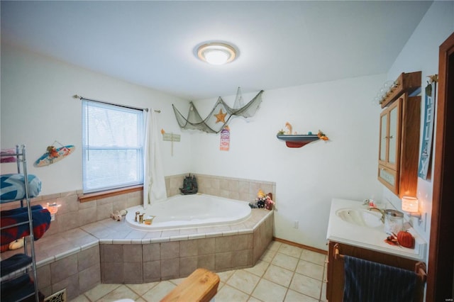 bathroom with tile patterned flooring, vanity, and a relaxing tiled tub