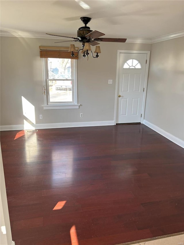 entryway with crown molding, ceiling fan, and dark wood-type flooring