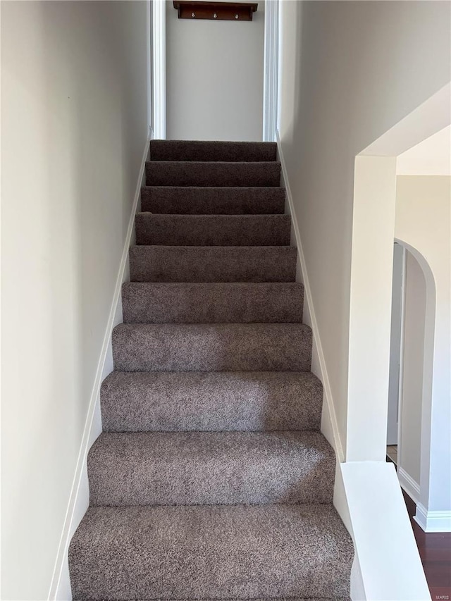 stairs with wood-type flooring