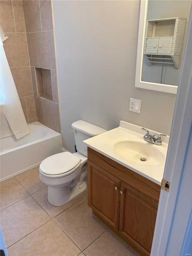 full bathroom featuring tile patterned flooring, tiled shower / bath combo, toilet, and vanity