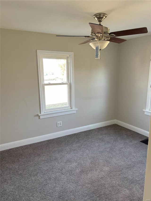 empty room featuring carpet flooring and ceiling fan