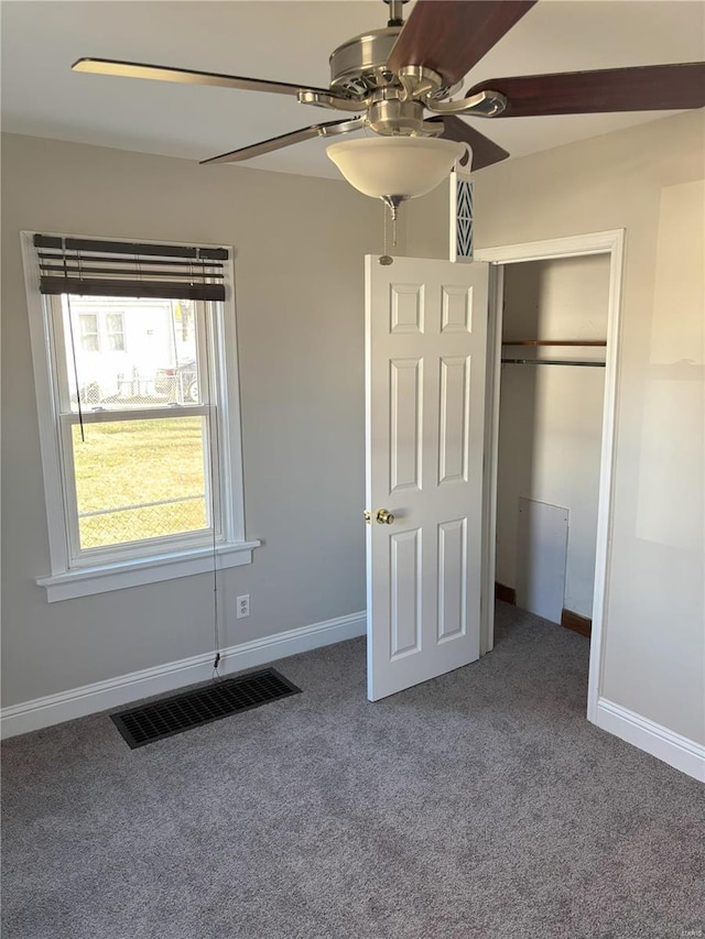 unfurnished bedroom with carpet flooring, a closet, and ceiling fan