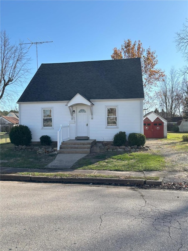 view of front of home featuring a storage shed