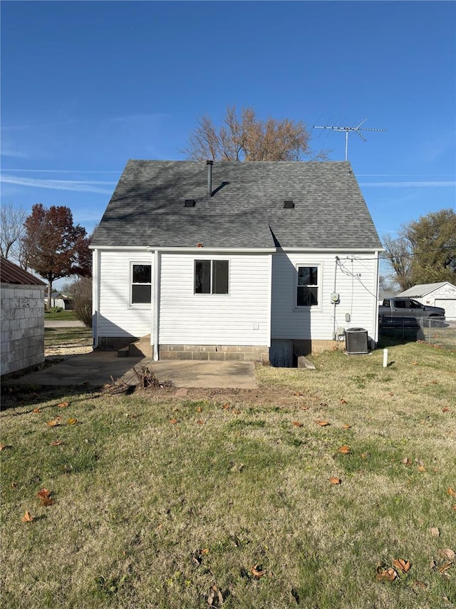 rear view of property featuring a yard and a patio