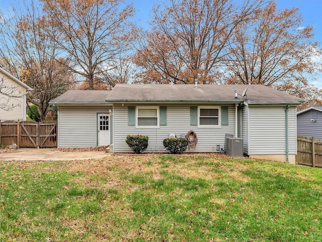 back of house featuring a lawn, a patio area, and cooling unit