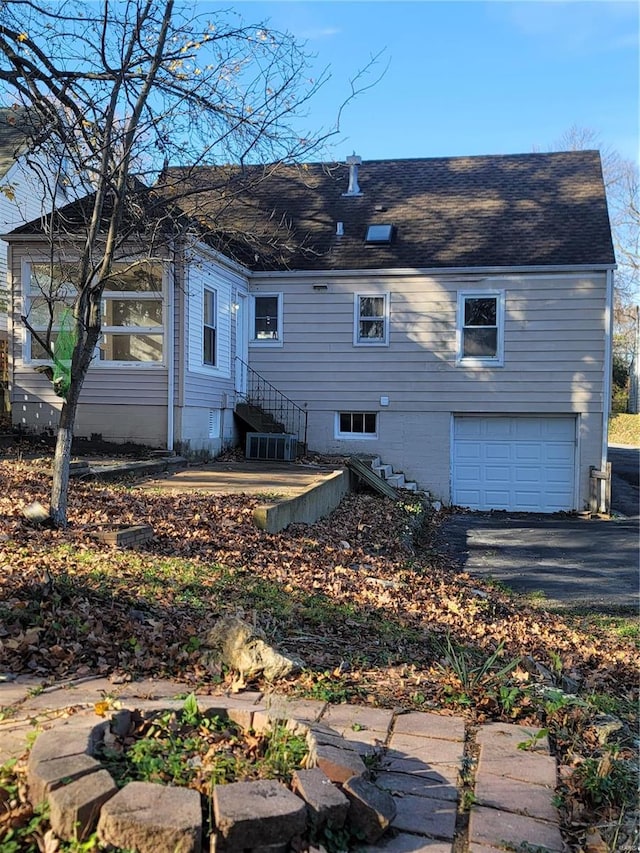 back of house with a garage